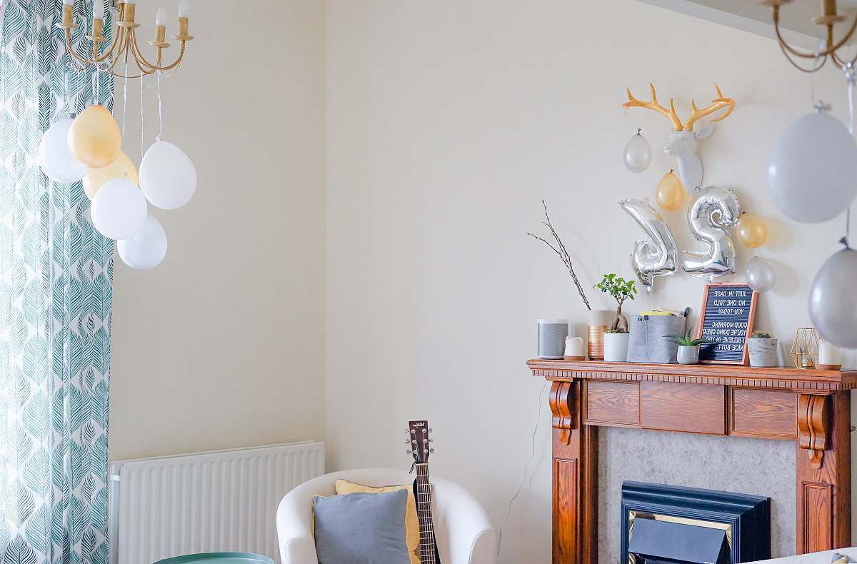 indoors white tub chair near wooden fireplace dining room